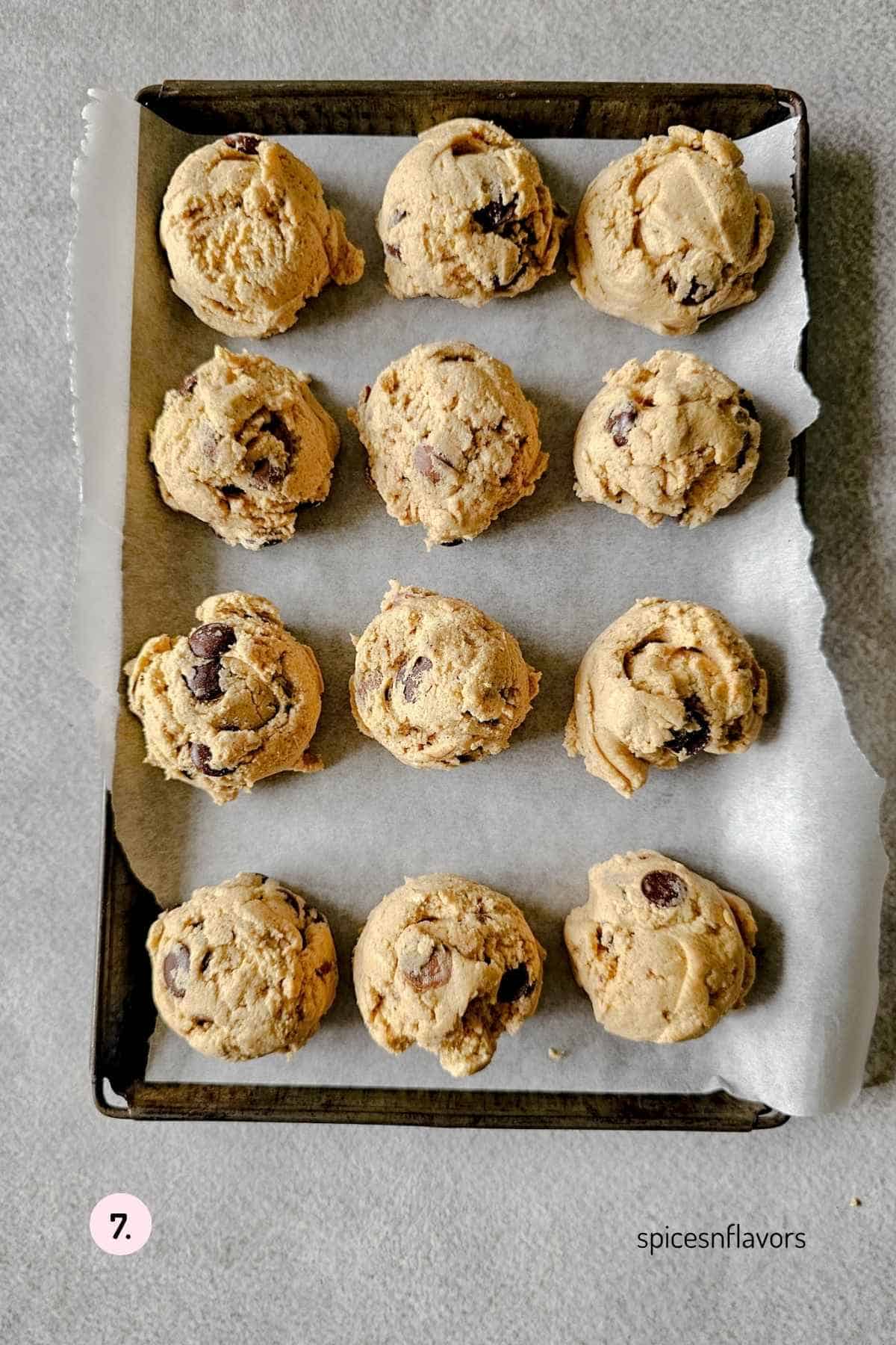 scoop cookie dough on to a baking tray lined with parchment paper