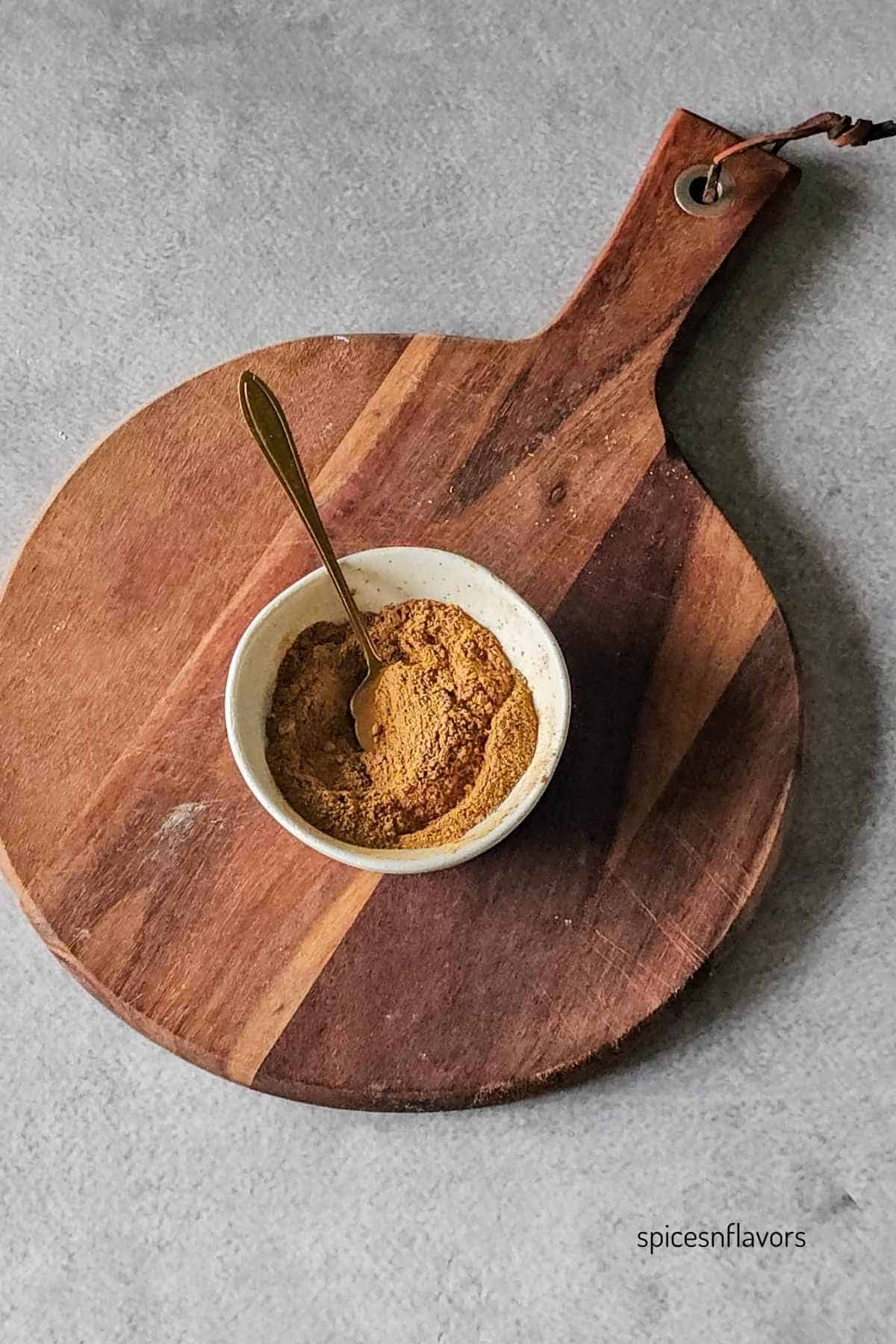 mixing masala chai spices in a small bowl