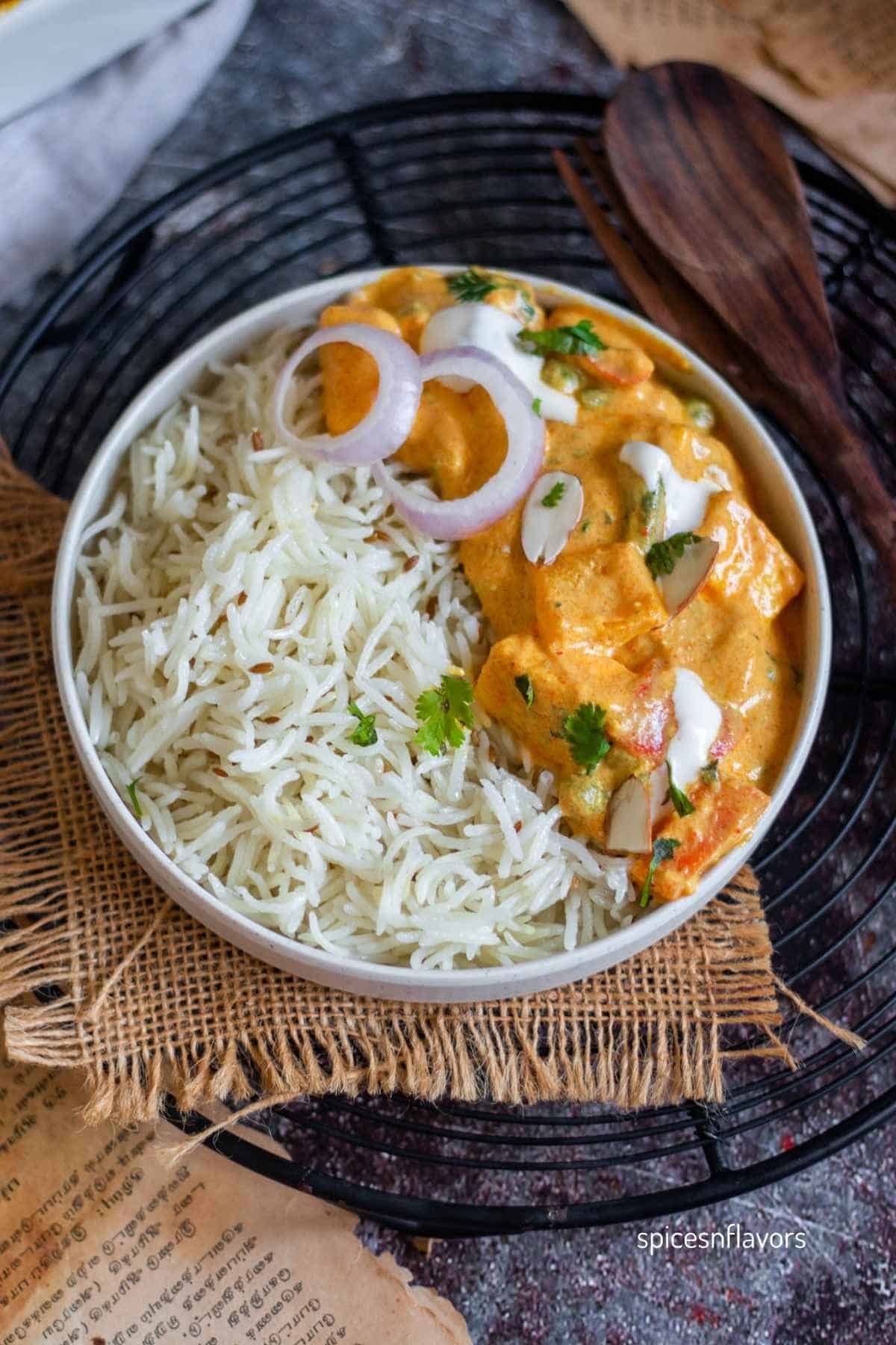 serve the oven baked vegetable paneer curry casserole with rice in a bowl