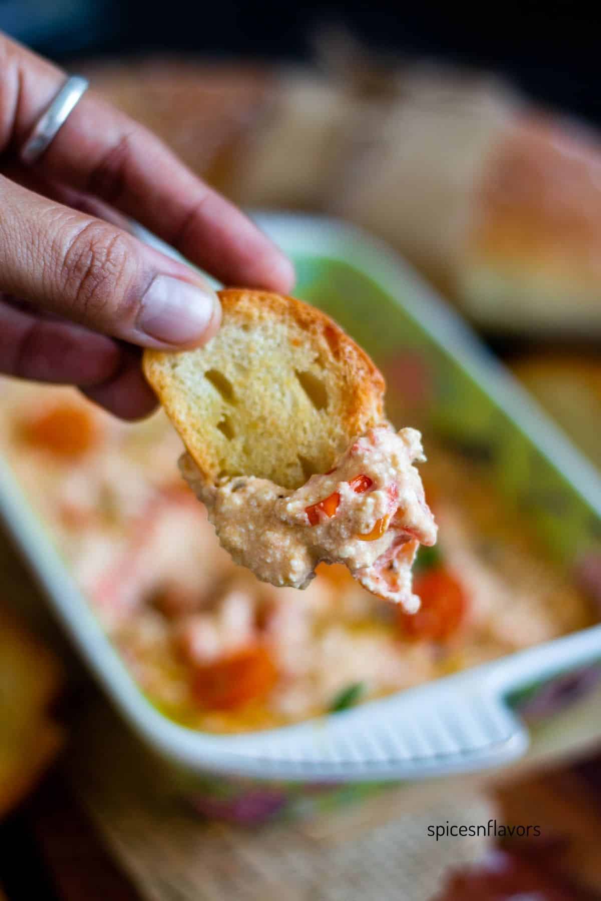 baguette bread dipped in baked feta dip