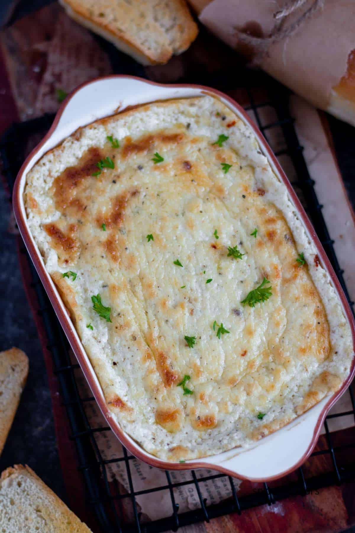 baked garlic bread dip placed on a wire rack