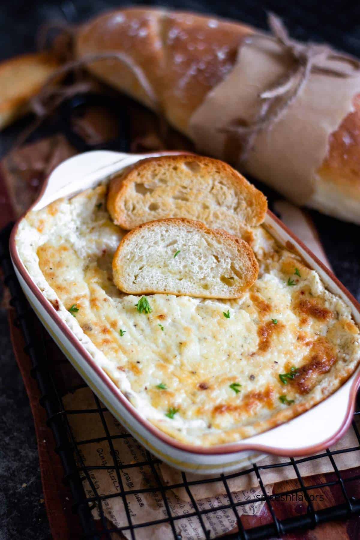 baked garlic bread dip with bread slices kept on top