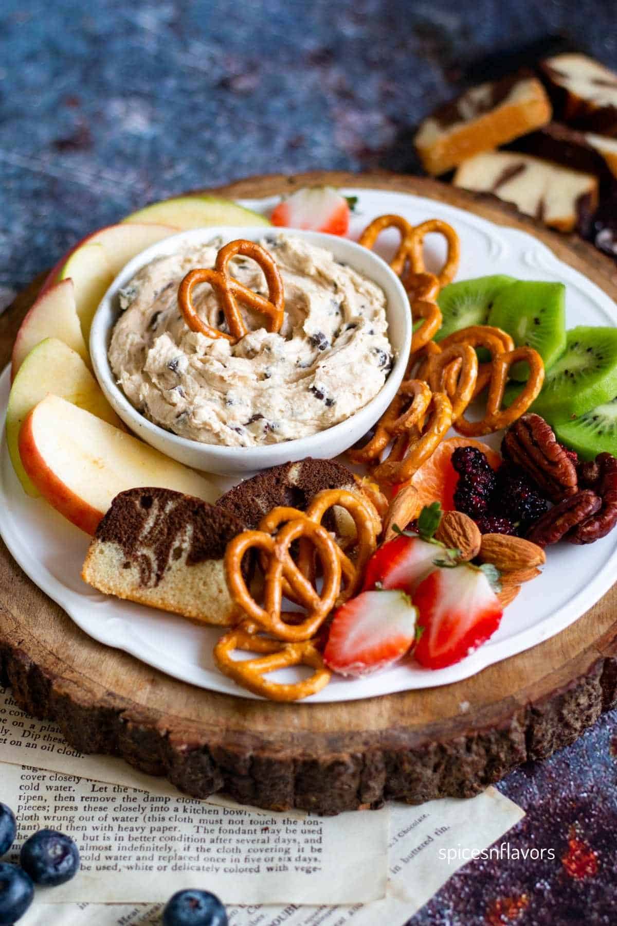 chocolate chip dip served in a bowl with dippers on the sides