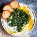 close up image of ricotta dip with herb oil on top to fit the recipe card image