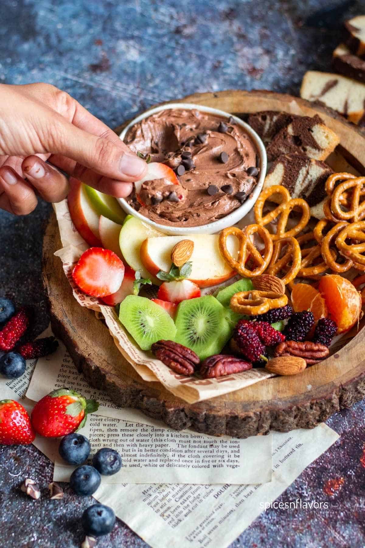 picking brownie batter dip using strawberry