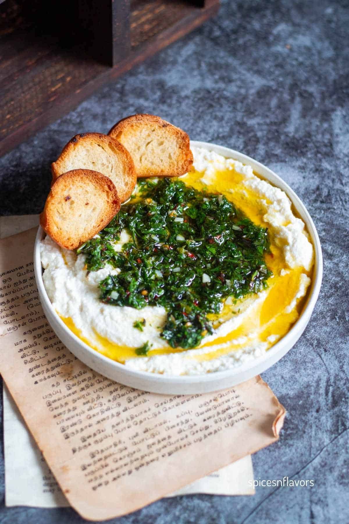 whipped ricotta dip with bread slices on the sides