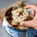 close up image of picking cranberry pistachio shortbread cookies