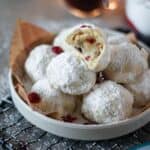 close up image of sliced cranberry orange snowball cookies for recipe card