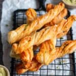 close up image of stacked garlic puff pastry twists