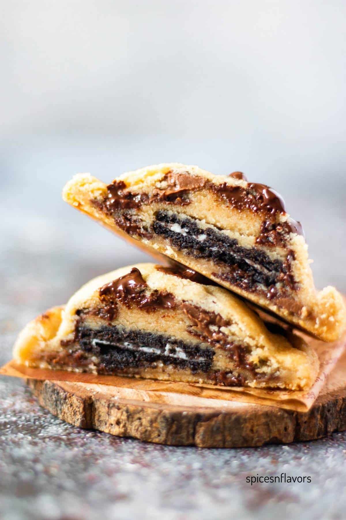 sliced oreo stuffed cookies placed on top of each other on a small wooden coaster