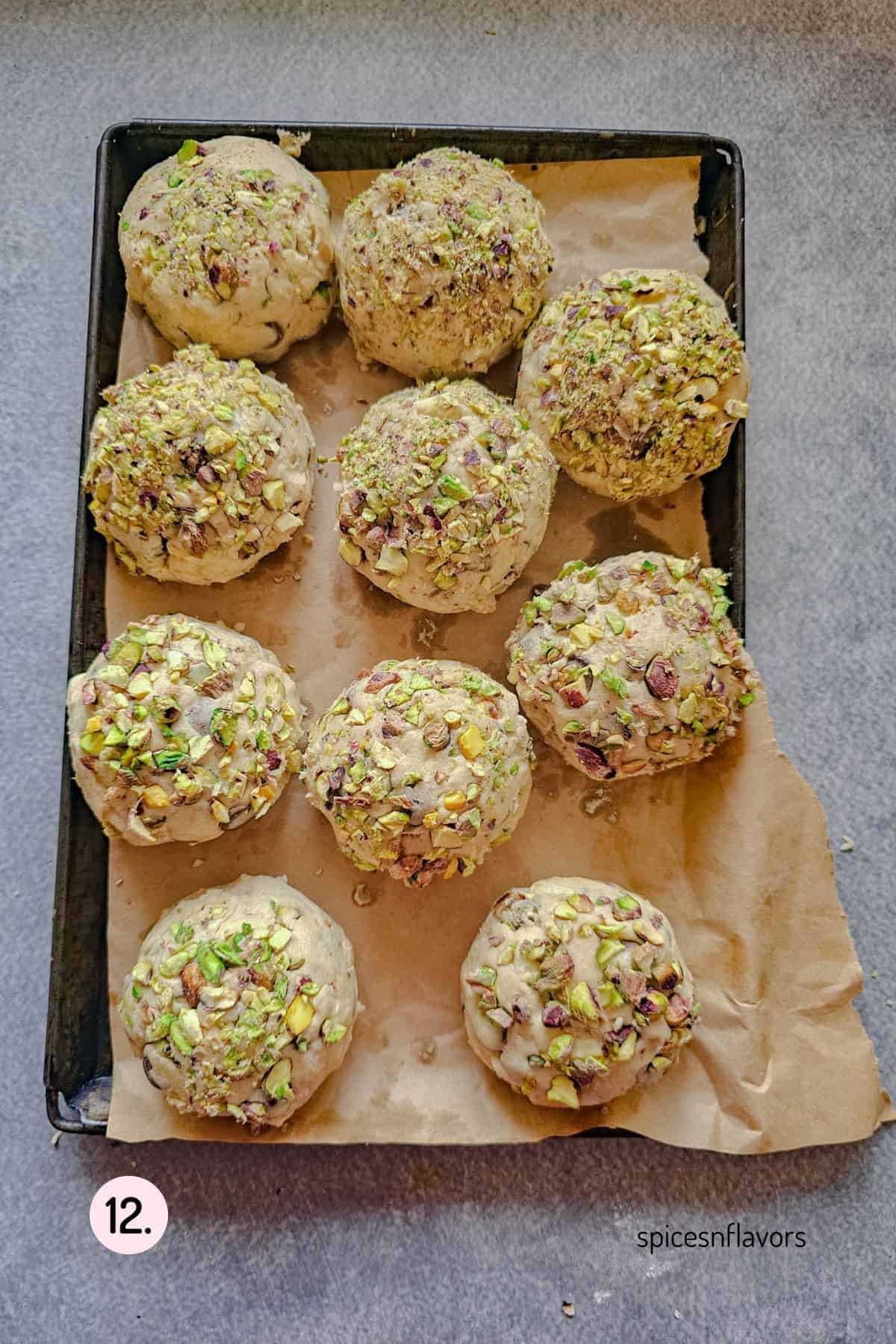 pistachio stuffed cookie dough balls placed on a baking tray