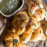 close up image of garlic knots on wooden board on recipe card