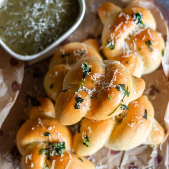 close up image of garlic knots on wooden board on recipe card