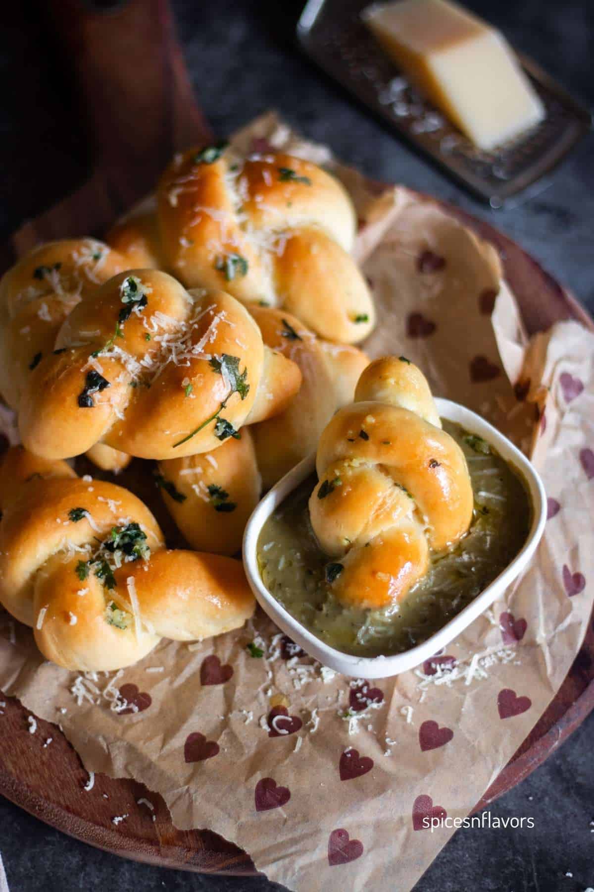 garlic knots dipped in pesto on the side