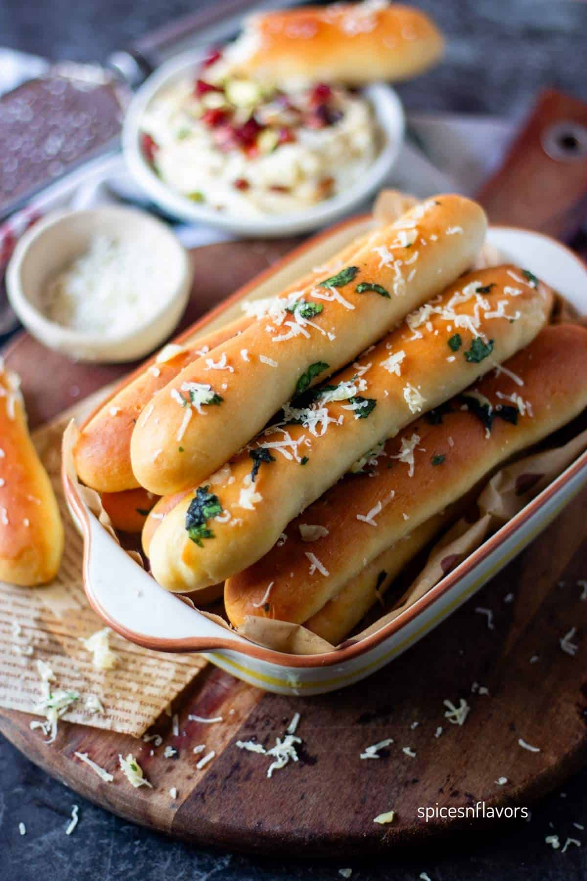 garlic breadsticks with dips on side
