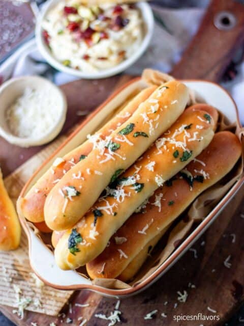 garlic breadsticks placed in an oval pan