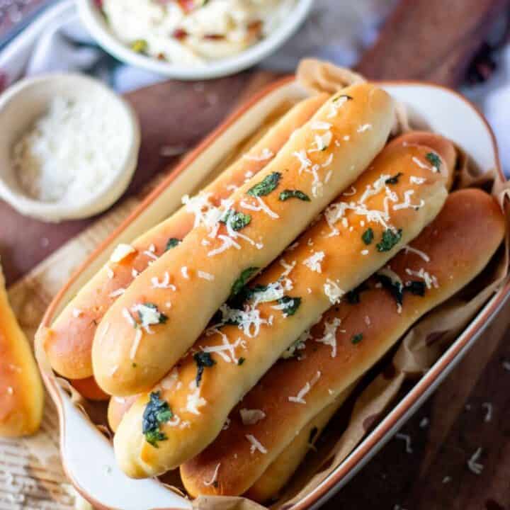 garlic breadsticks placed in an oval pan